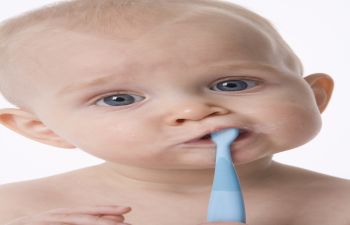Baby With Toothbrush in Their Mouth