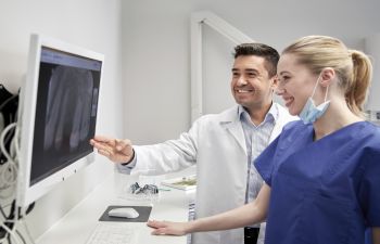 dentists reviewing digital dental imaging