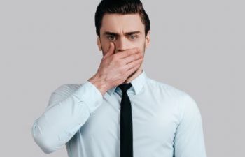 Man Covering His Mouth Due to Bad Breath