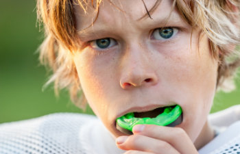 Boy putting in his mouth guard